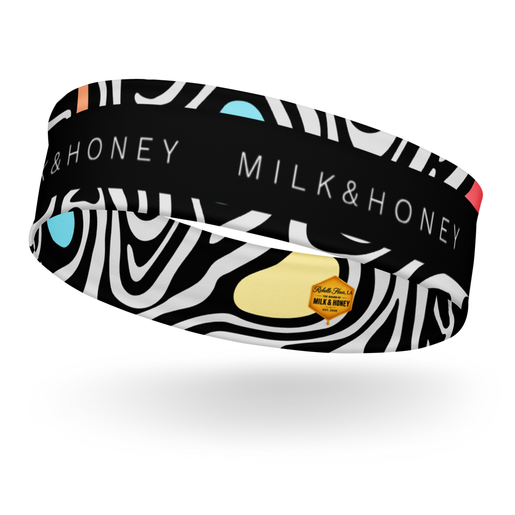 Black headband with white zebra swirls, MILK & HONEY text, blue and yellow accent shapes and small hexagon brand label