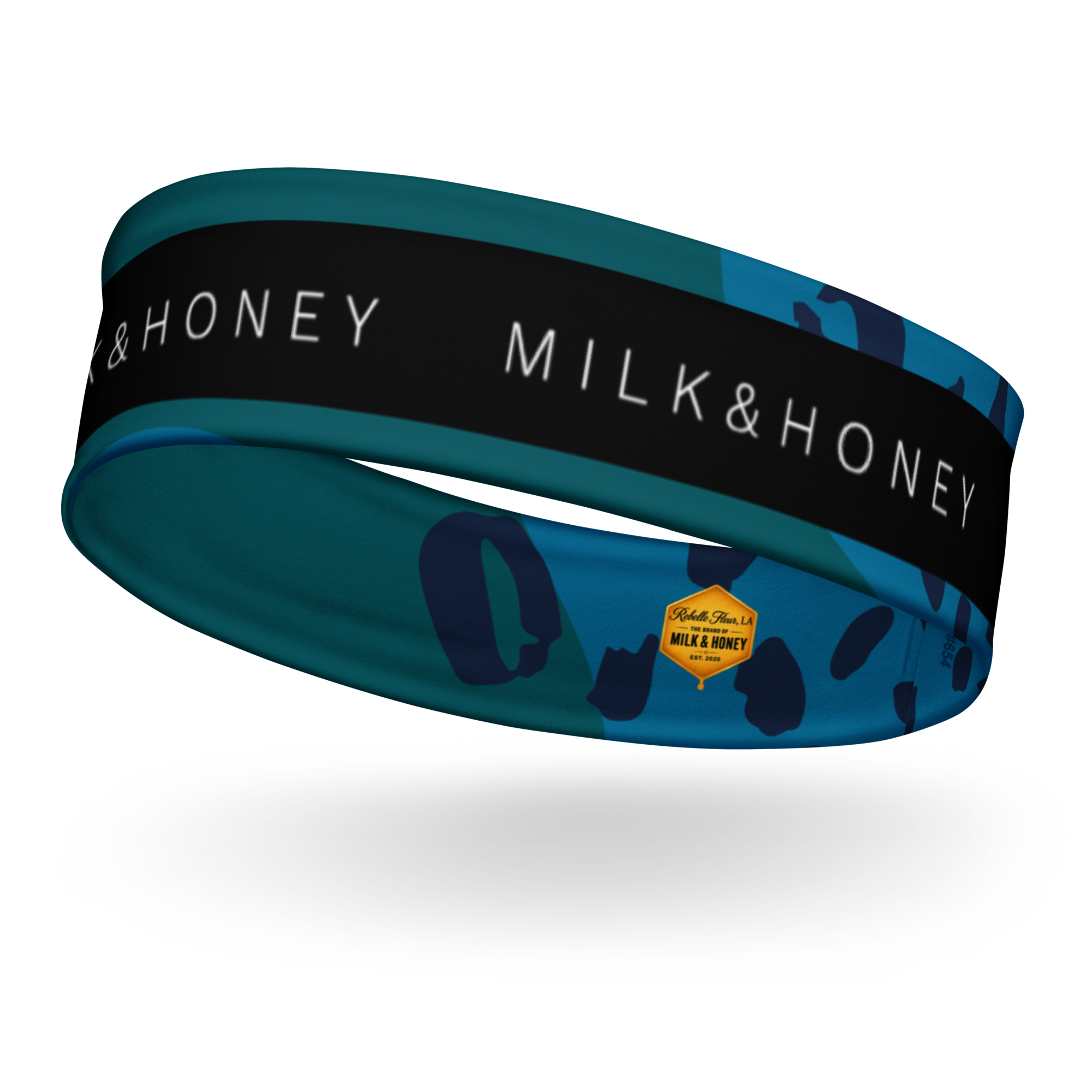 teal patterned headband with black band reading 'MILK & HONEY' and small yellow Rebelle Fleur hexagon logo