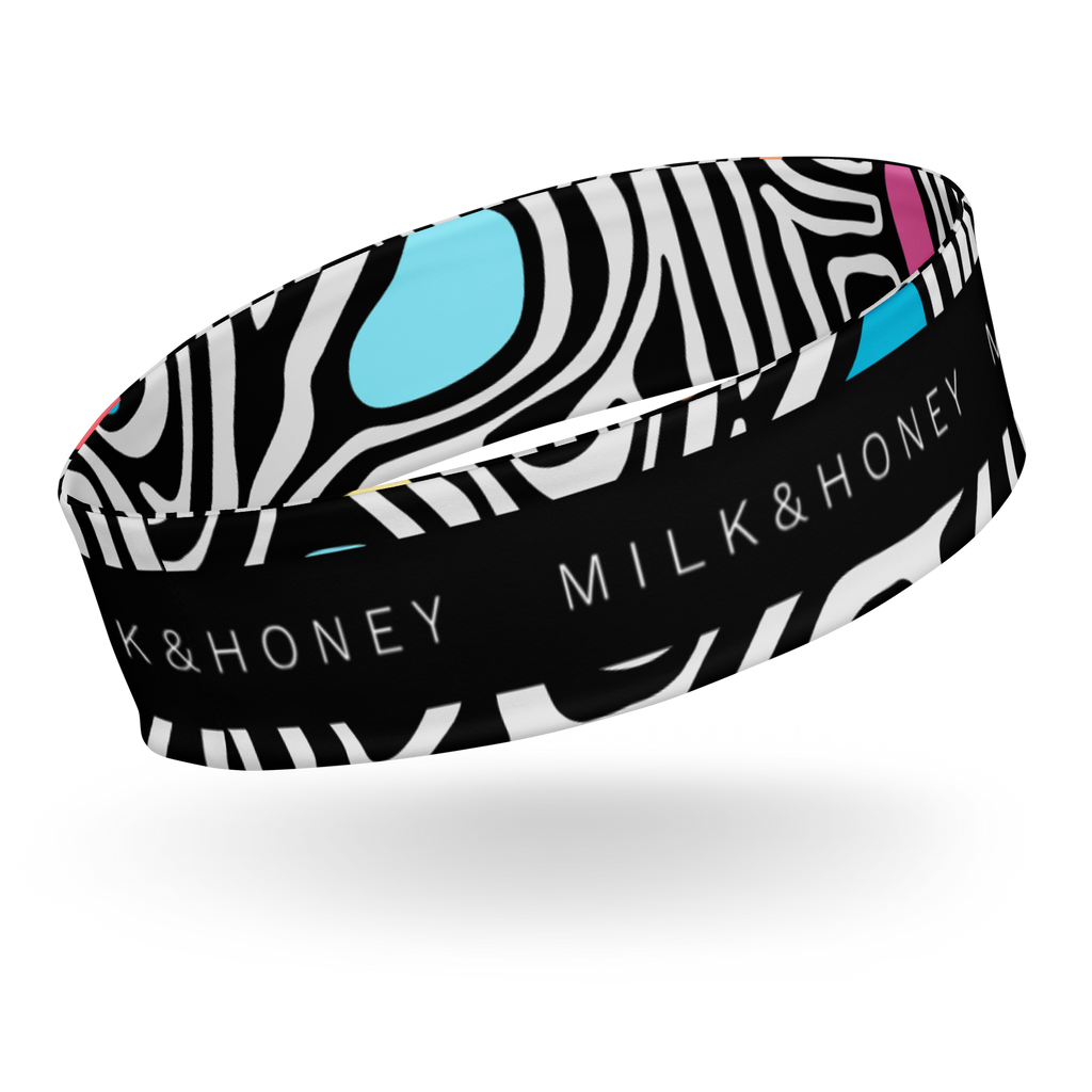 Black-and-white zebra patterned headband with turquoise and pink accents and visible 'MILK & HONEY' text