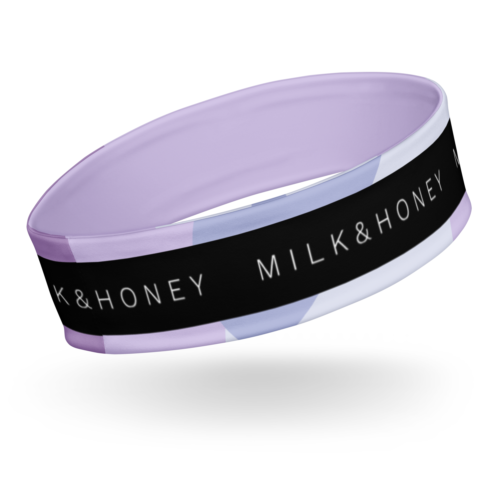 Lavender-lined stretchy headband with black outer band showing partial 'MILK & HONEY' text and pastel geometric stripes