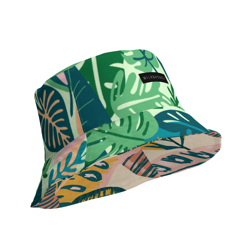 Reversible bucket hat with green tropical leaf print and black MILK&HONEY label