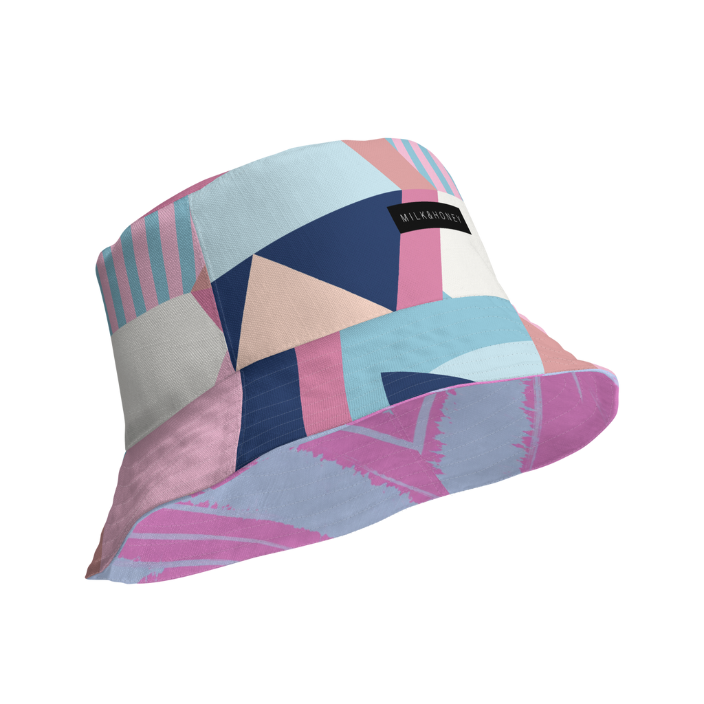 Pastel geometric patchwork bucket hat with stripes, triangles and a black 'MILK&HONEY' fabric label