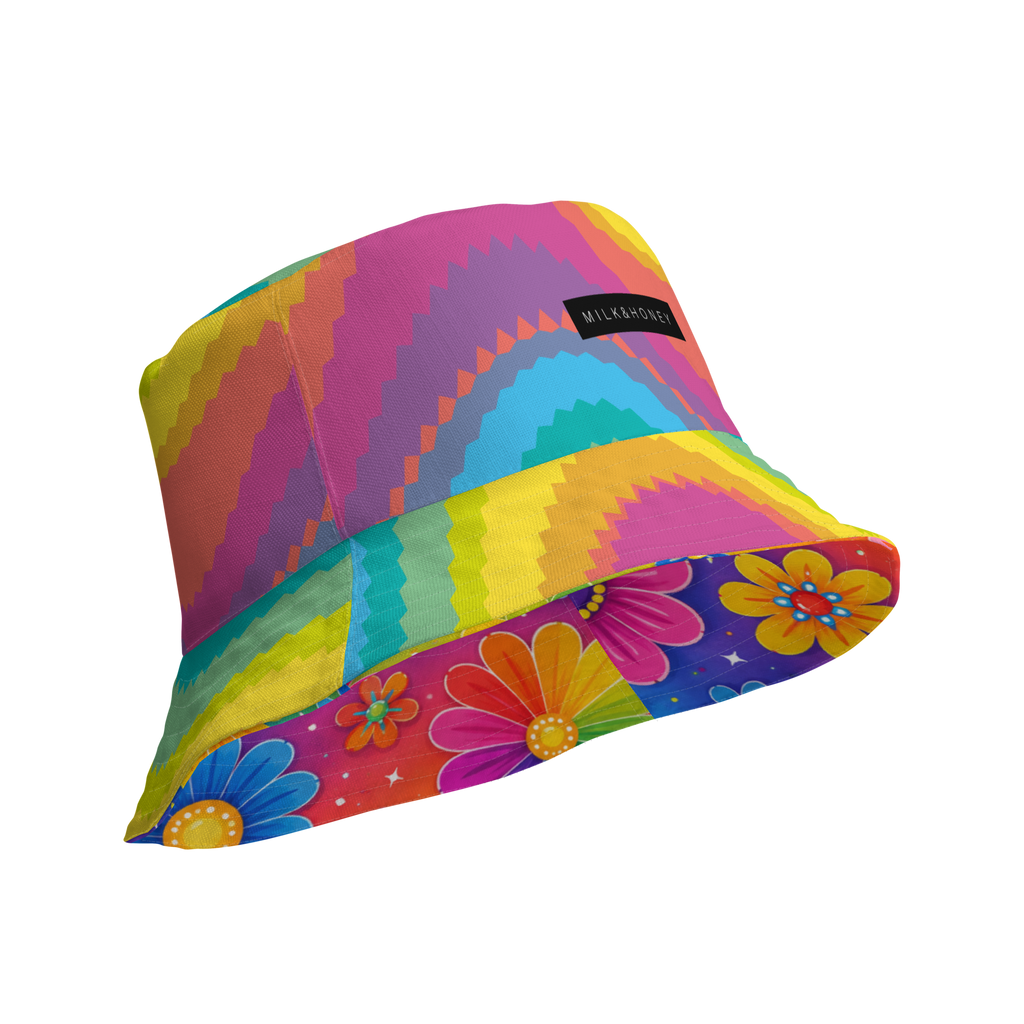 Bucket hat with concentric zigzag rainbow pattern, floral-printed underside and small black label reading 'MILK&HONEY'
