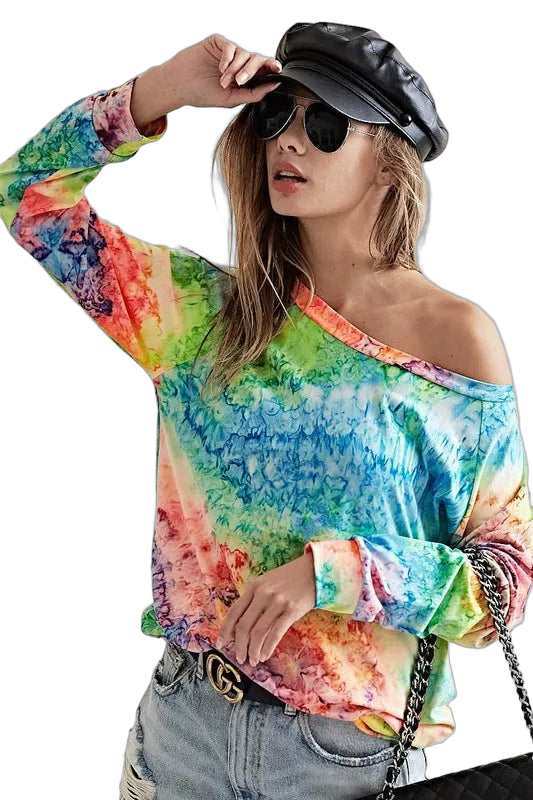 Model wearing multicolor tie-dye long-sleeve knit tee with slouchy off-shoulder neckline, sunglasses, leather cap, jeans