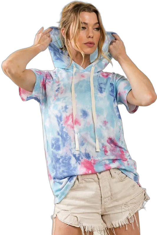Model wearing pastel tie-dye hooded top with long cream drawstrings and frayed beige shorts