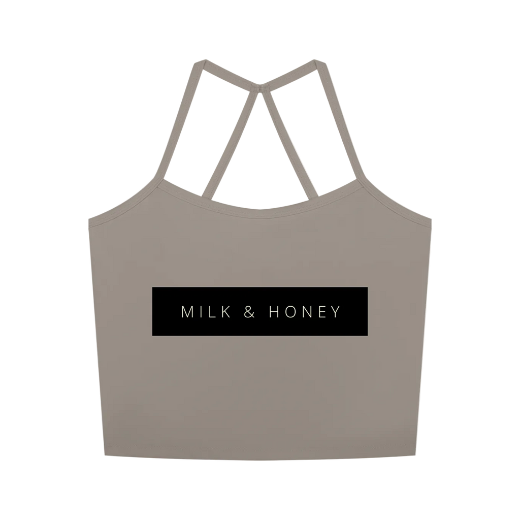 Sleeveless cropped tank with double V-back straps and centered black rectangle reading 'MILK & HONEY'