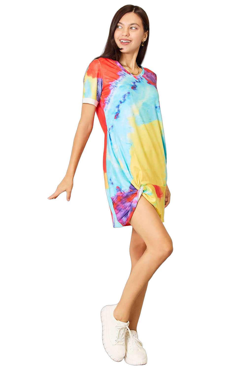 Model wearing short V-neck multicolor tie-dye dress with short sleeves, side knot twist hem, and white sneakers