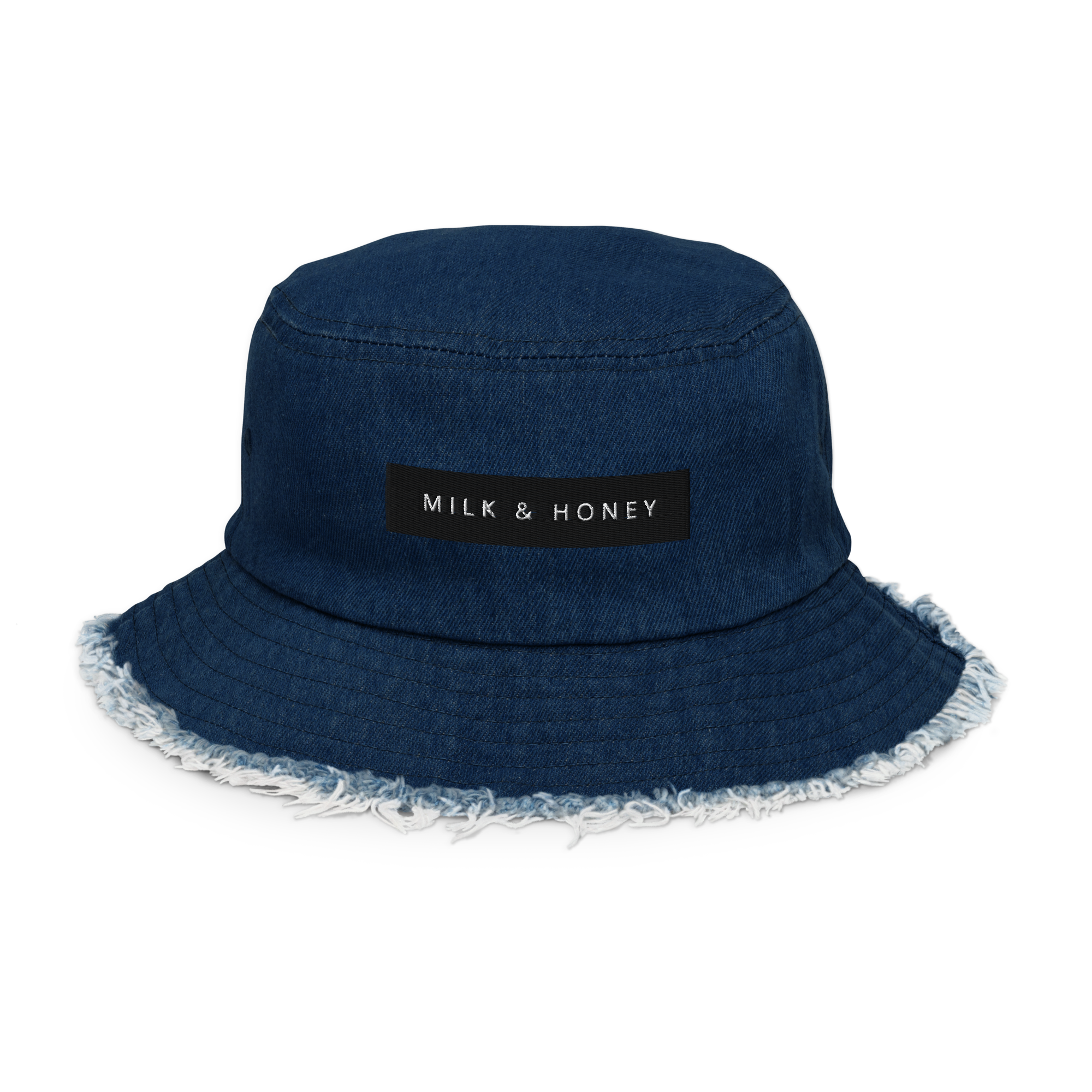 Denim bucket hat with black 'MILK & HONEY' patch, visible top stitching and frayed brim edge