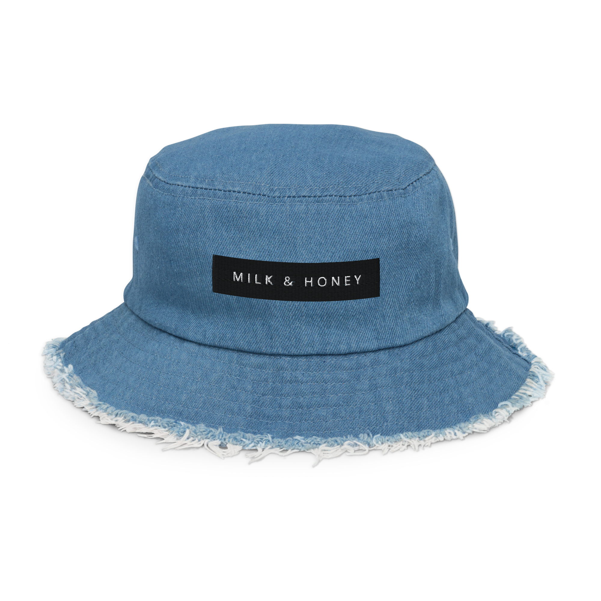 Light denim bucket hat with frayed brim and black rectangular 'MILK & HONEY' label