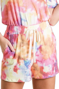 Pink multi tie-dye French terry shorts with elastic drawstring waist and side pockets, worn with matching top