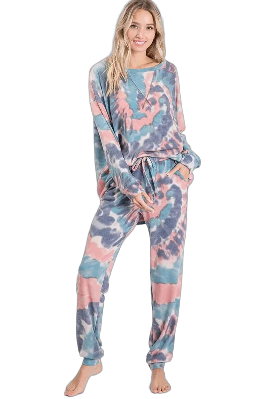 Model wearing pastel tie-dye lounge pants with drawstring waistband and side pockets, paired with matching long-sleeve top