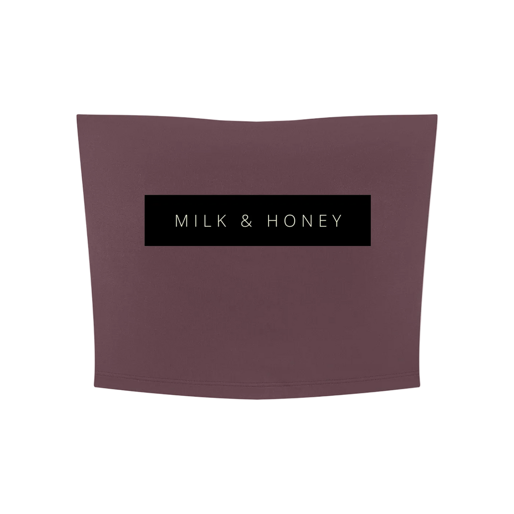Cropped strapless tube top in muted rose with centered black 'MILK & HONEY' label