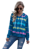 Model wearing sky-blue tie-dye hooded pullover with white drawstrings and raglan long sleeves, paired with ripped jeans