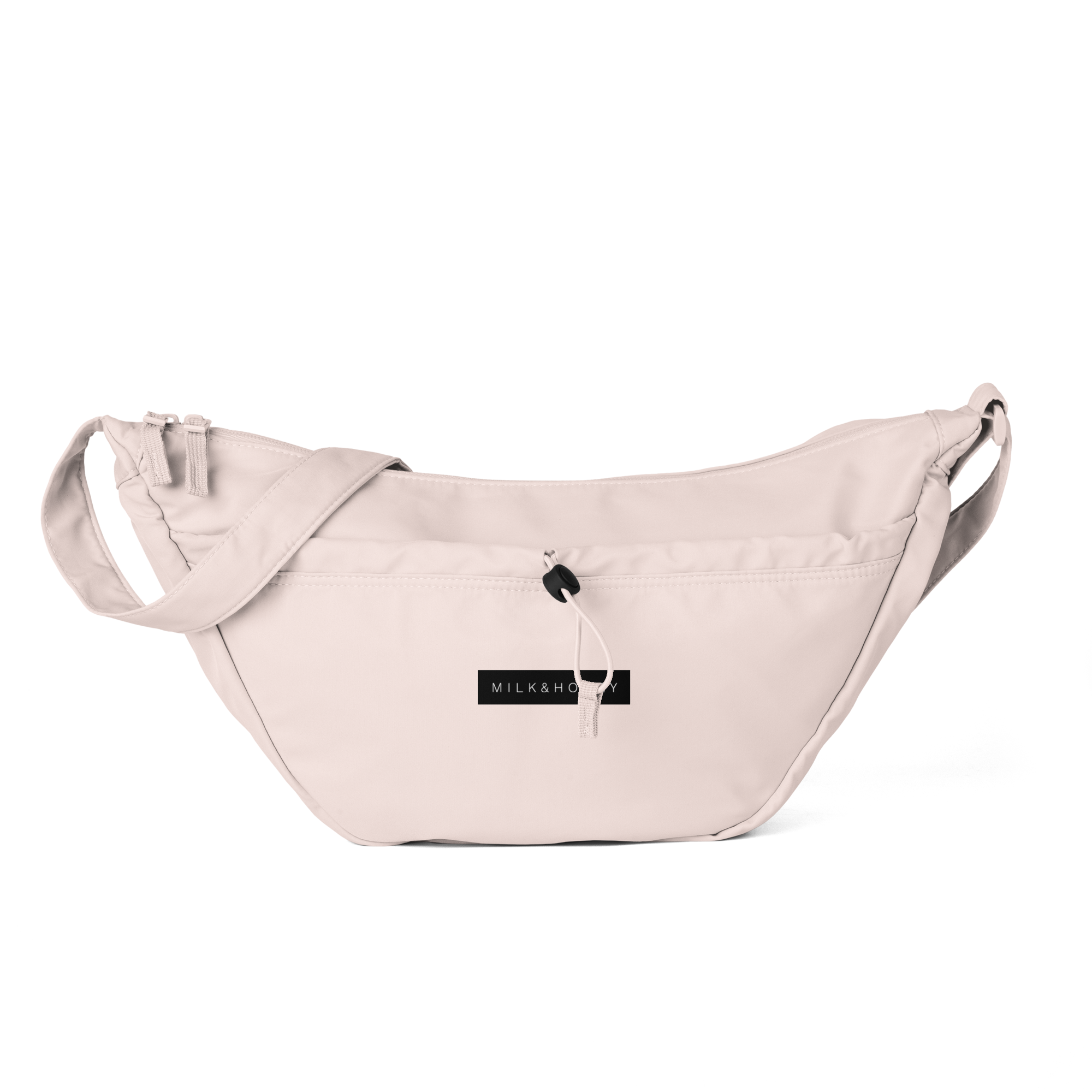 Light pink crossbody bag top with adjustable strap, front pocket, cord toggle and black MILK&HONEY label
