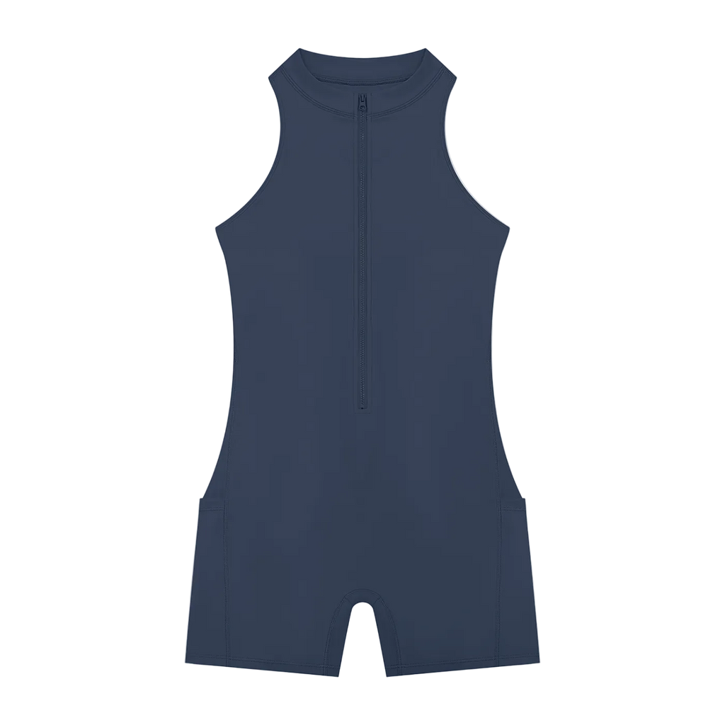 Sleeveless high-neck romper with center quarter-zip, short legs and subtle side seam pockets, flat-lay on black background