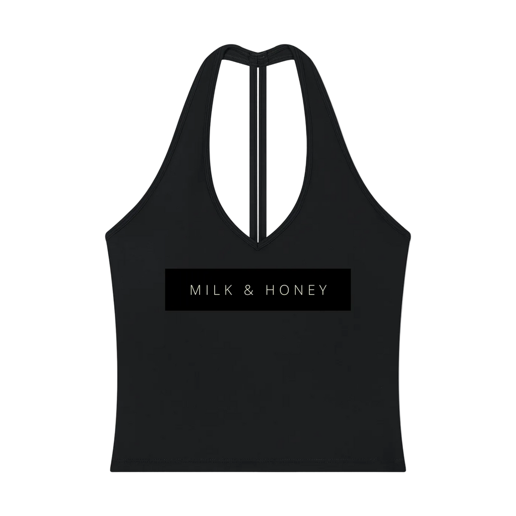 Black halter V-neck crop tank with narrow center-back strap and rectangular 'MILK & HONEY' chest print.