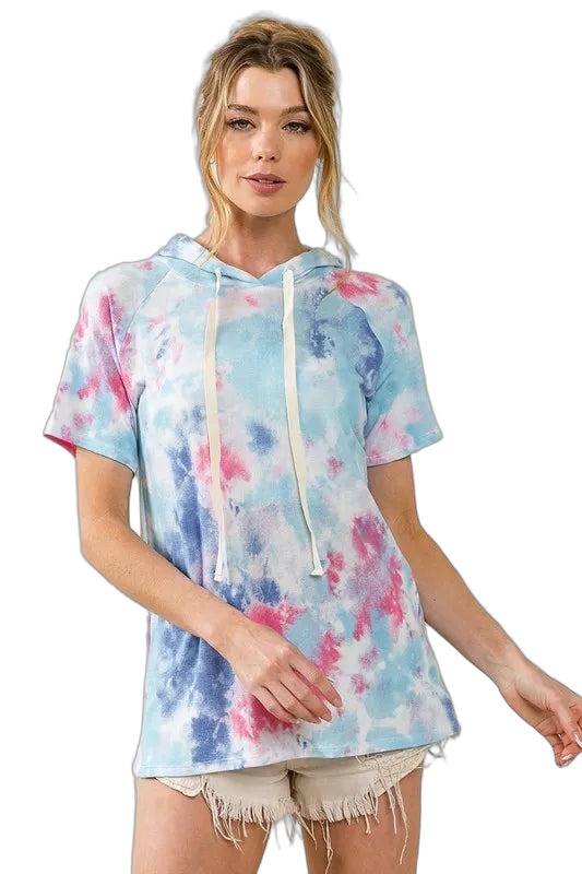 Model wearing aqua blue tie-dye short-sleeve terry hoodie with cream drawstrings and frayed light shorts