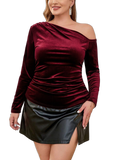 Burgundy velvet one-shoulder long-sleeve blouse with ruched front, paired with a black skirt featuring a front slit