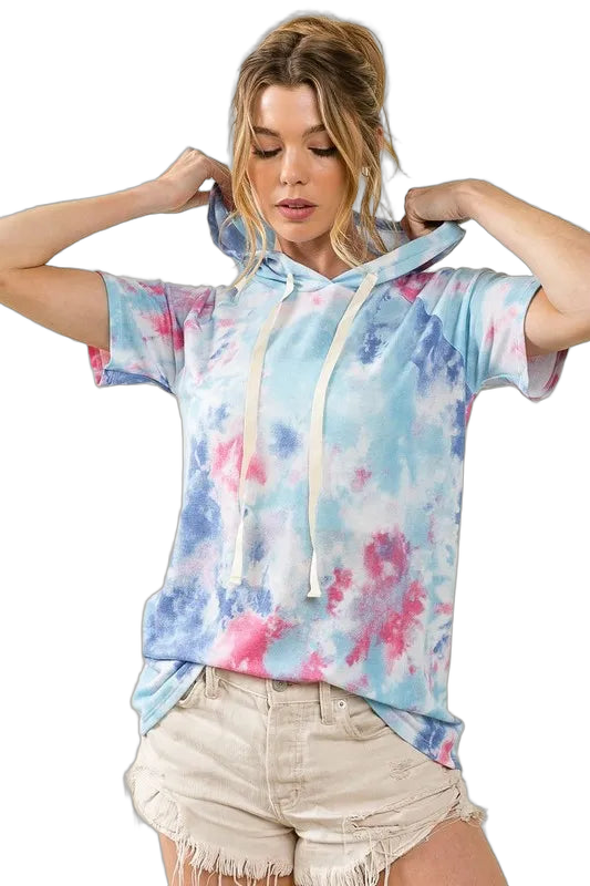 Woman wearing pastel blue and pink tie-dye short-sleeve hoodie with long cream drawstrings