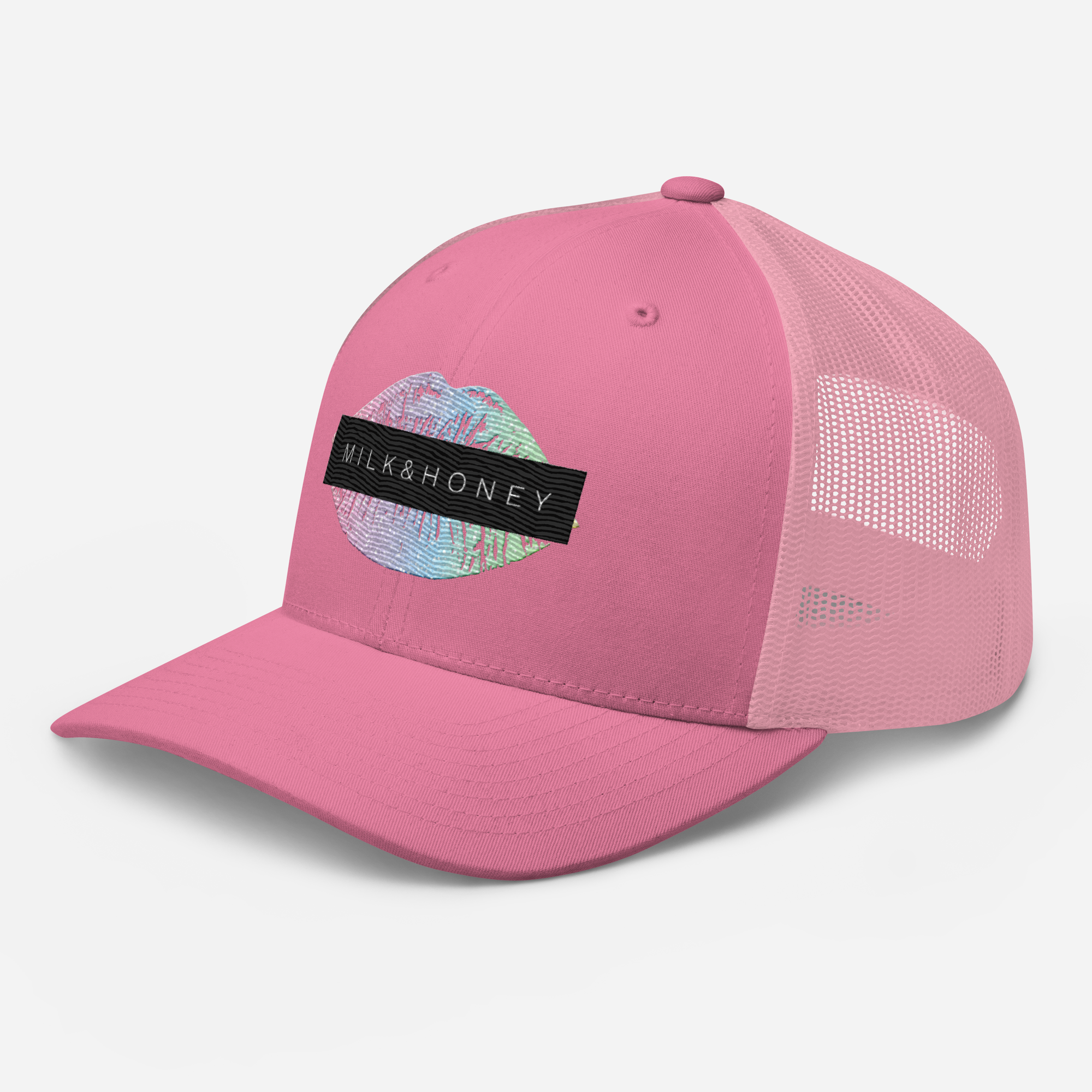 Pink six-panel trucker cap with mesh back, curved visor, embroidered multicolor circular patch and black 'MILK&HONEY' label.
