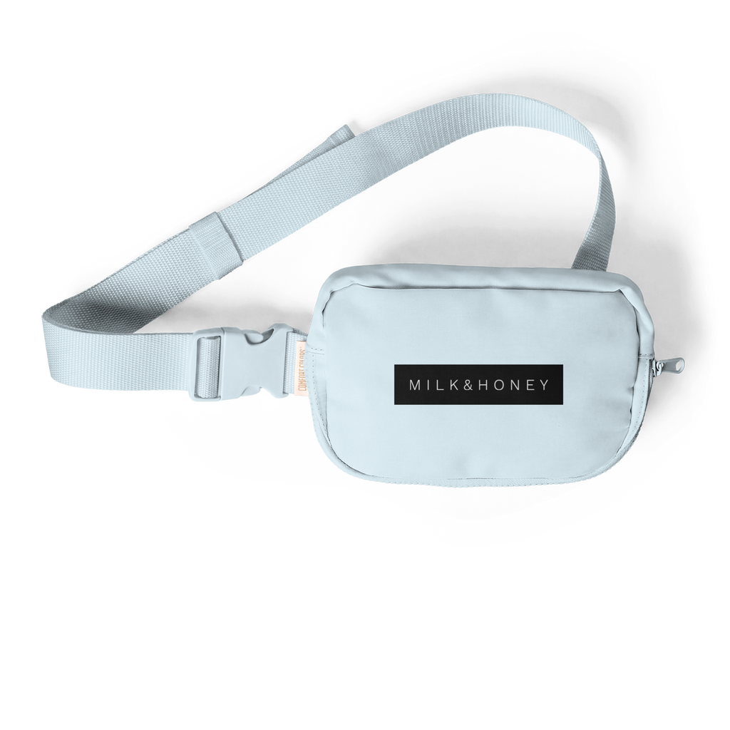 Woven adjustable strap, plastic side-release buckle and partial sling pouch with 'MILK&HONEY' label on black background